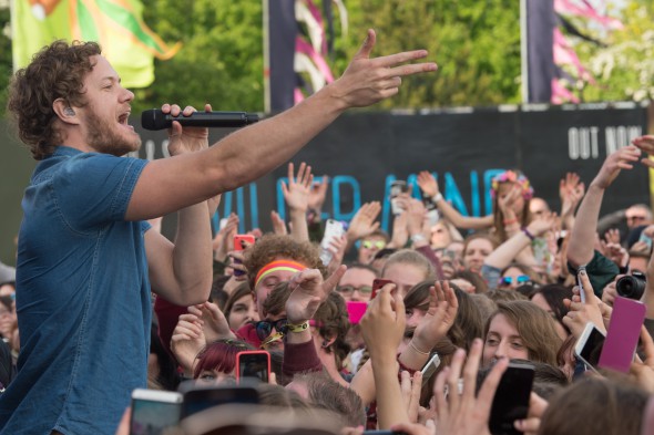 Dan Reynolds of Imagine Dragons amidst a festival crowd Dan Reynolds of Imagine Dragons amidst a festival crowd