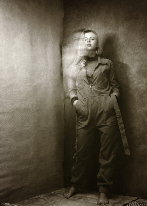Artistic mid length black and white portrait of women with light background and motion blur. Artistic mid length black and white portrait of women with light background and motion blur.