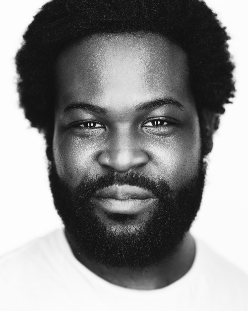 Black and white professional headshot of male with light background and clothing Black and white professional headshot of male with light background and clothing
