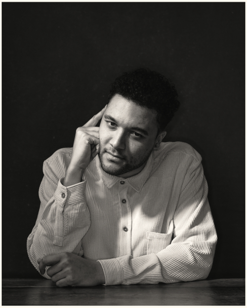 B&W portrait of man sitting at a table B&W portrait of man sitting at a table